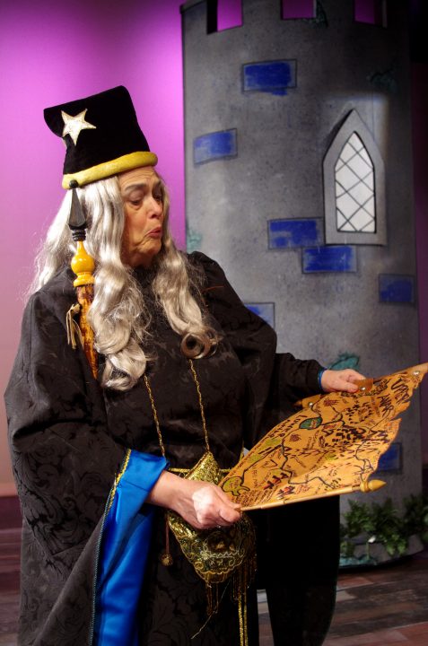 Merlin reads the map in King Arthurs Court.